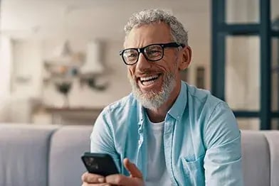 happy-older-man-with-phone-392x262