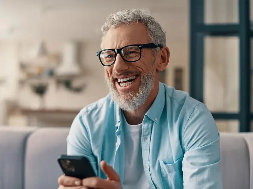 happy-older-man-with-phone-840x628
