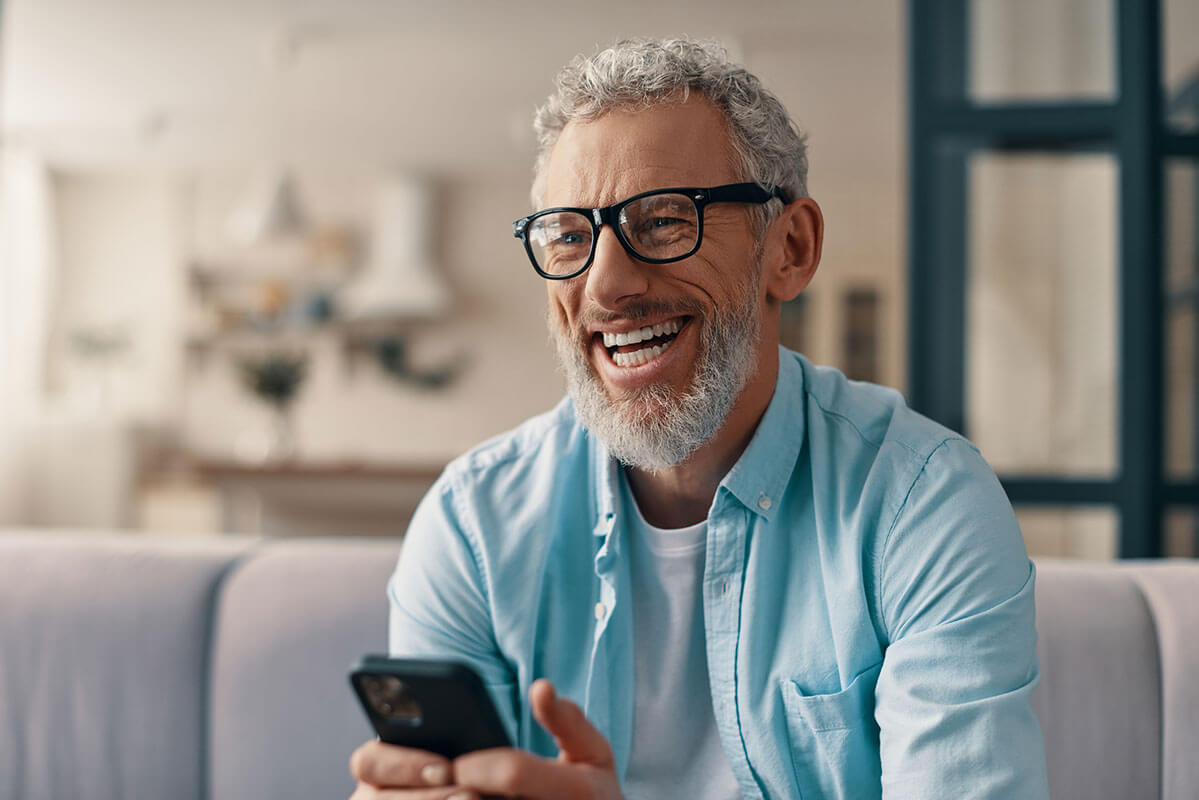 happy-older-man-with-phone